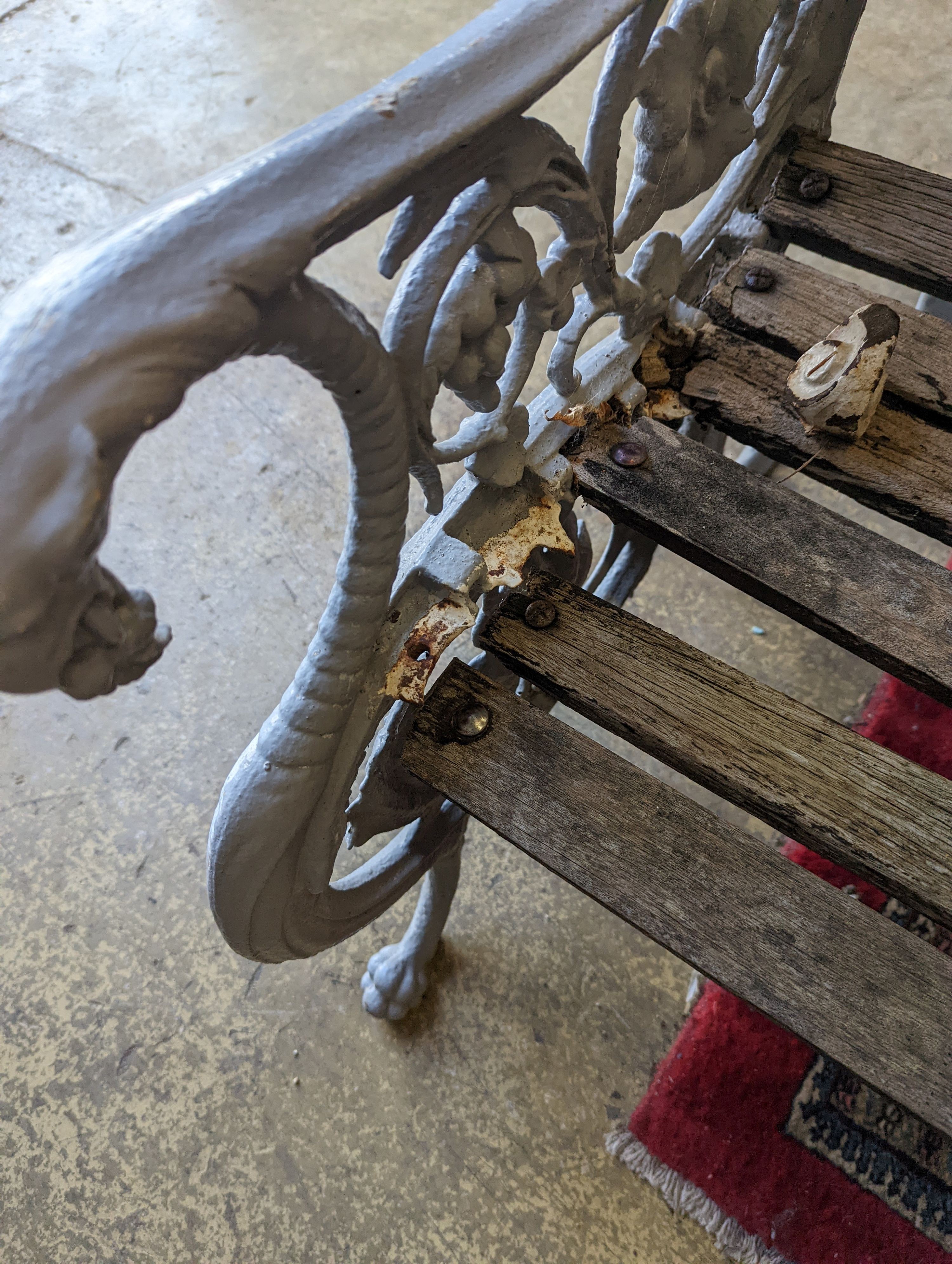 A Victorian Coalbrookdale cast-iron garden bench, length 156cm, depth 68cm, height 94cm (re-painted and seat in need of repair)